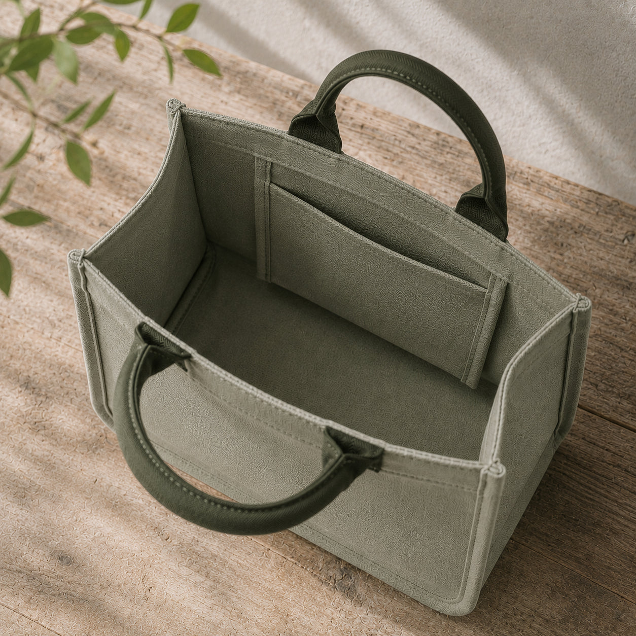 Open interior of sage green mini canvas tote with forest green handles and inner pocket.
