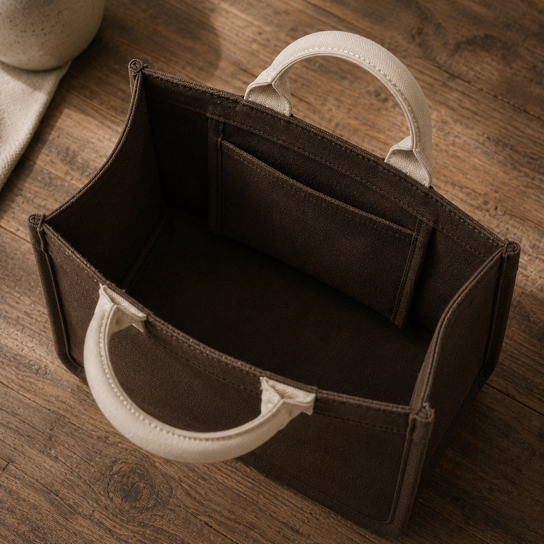 Raw umber brown mini canvas tote with oatmeal handles, soft structured cotton canvas shape.