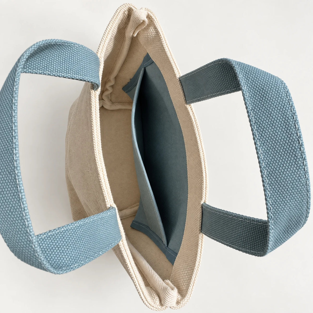 Dune Mini Canvas Tote — interior view showing the side slip pocket, folded rim and bound seams.