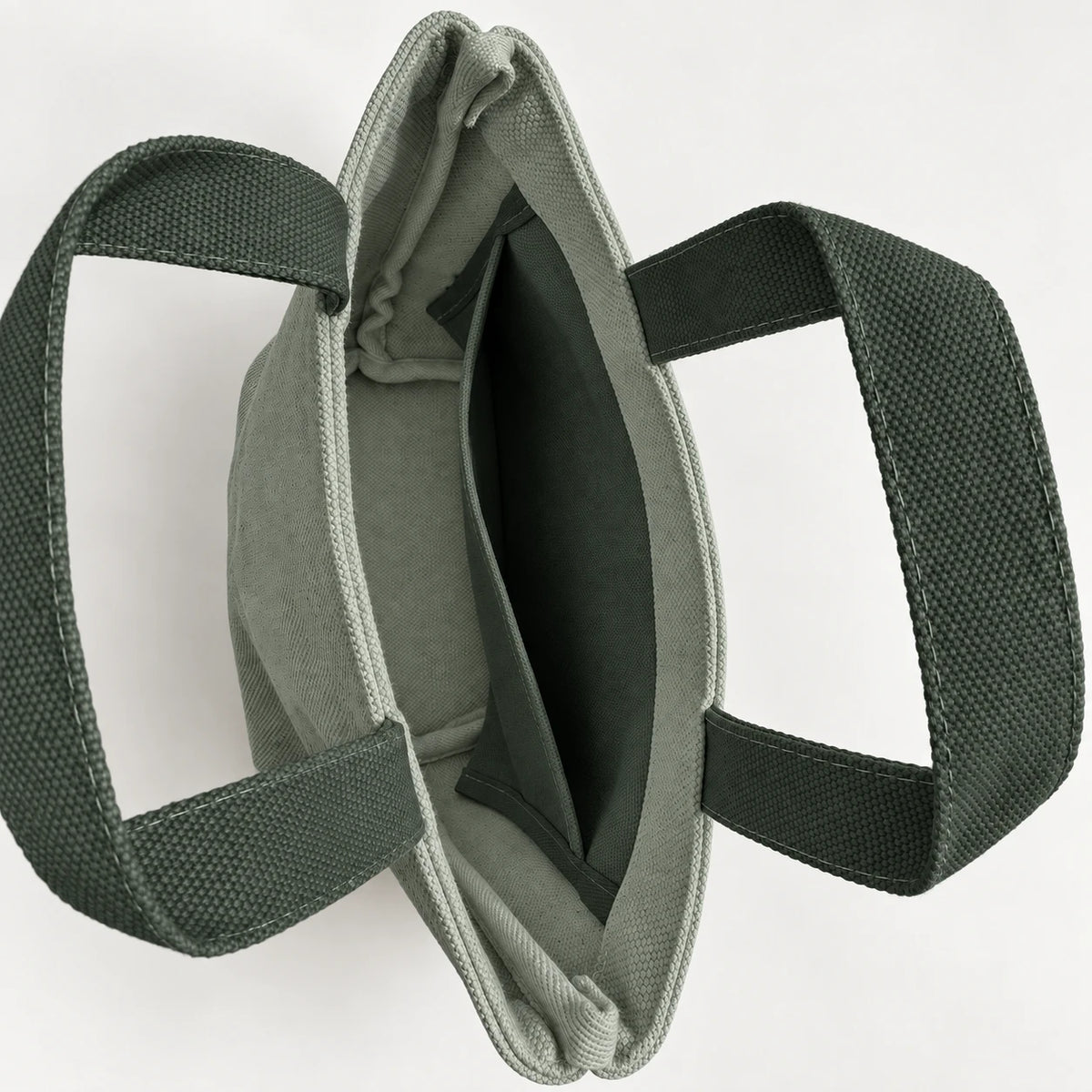 Forest Mini Canvas Tote — interior view showing the side slip pocket, folded rim and bound seams.