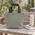 Forest Mini Canvas Tote on a garden bench beside a small book and thermos.