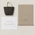 Umber Mini Canvas Tote with the original PLANEA packaging presentation.